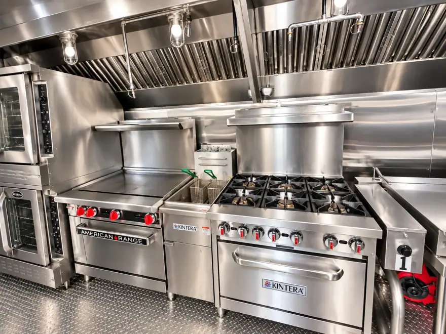 Cooking line inside a portable kitchen trailer with range, griddle and fryer