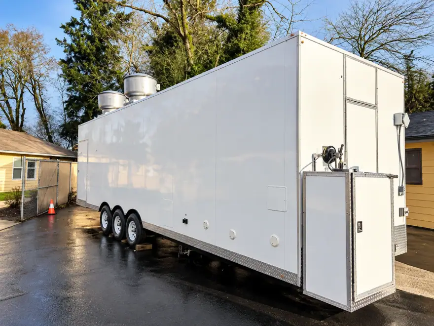Mobile commercial kitchen trailer for rent with an exterior service window
